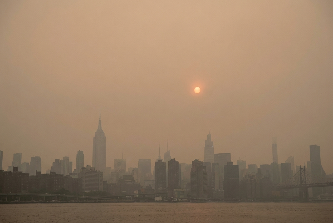 A city skyline under heavy smoke haze